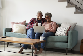 Life Assure Senior Couple Sitting On Sofa At Home Blog